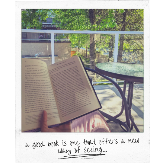 Polaroid of a girl reading a book outside on a balcony. Handwritten text reads, 'A good book is one that offers a new way of seeing.'